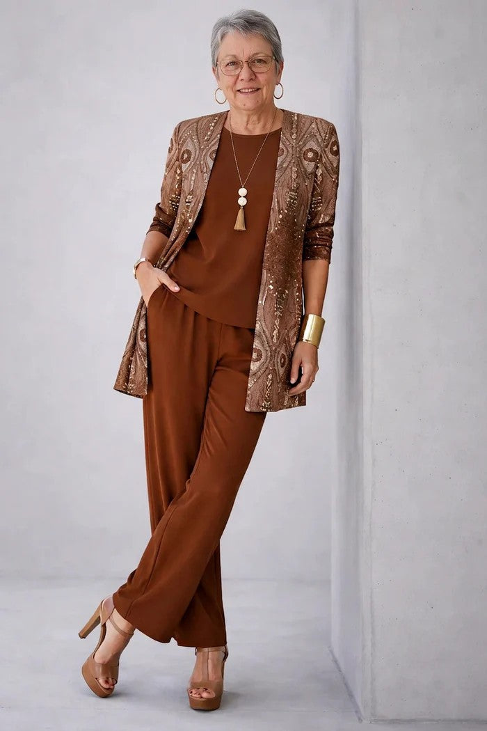 Older model leans against a wall in the brown set, the cardigan patterned in bronze and sequins 16