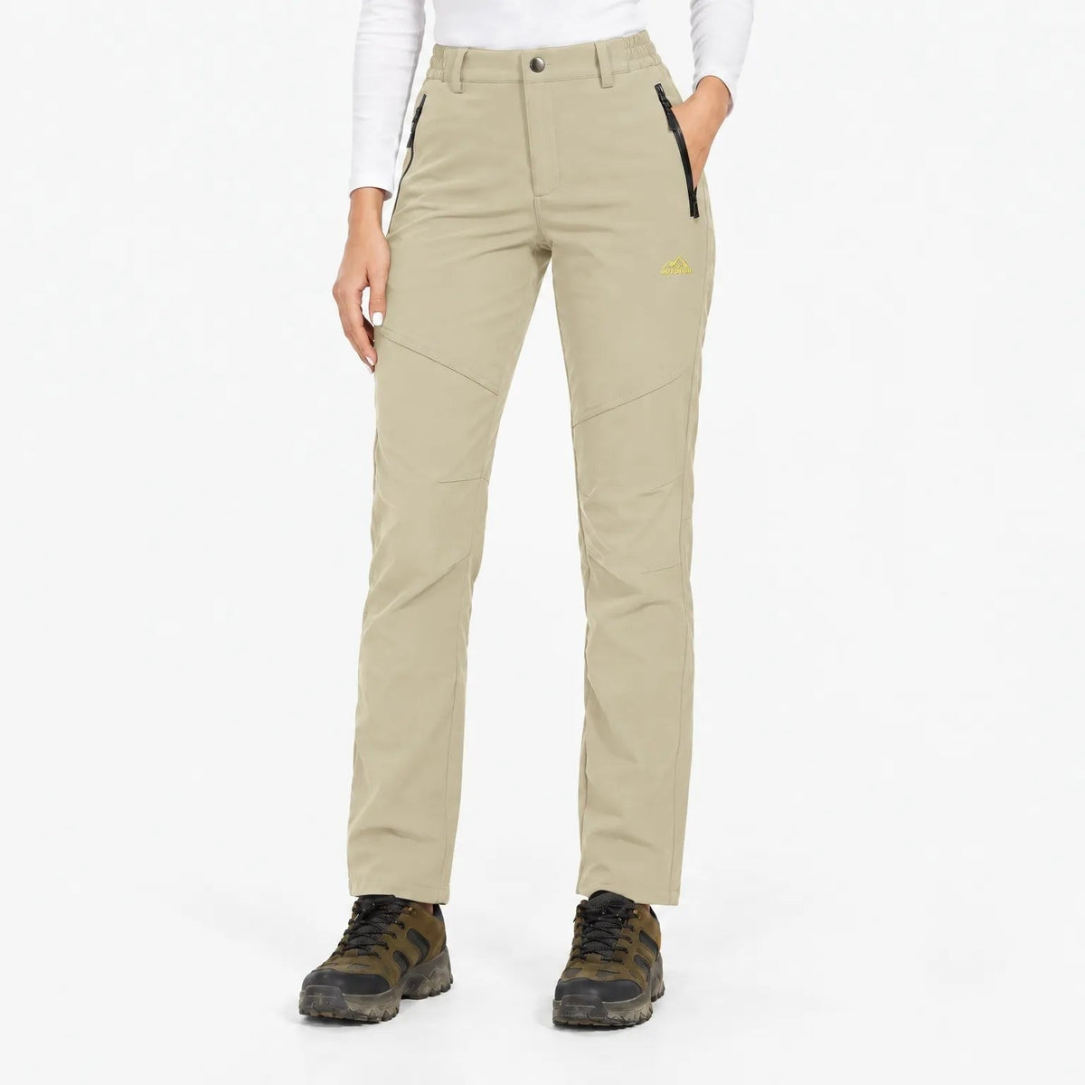 Front view of the trousers in a pale sand beige with black pocket zips 14