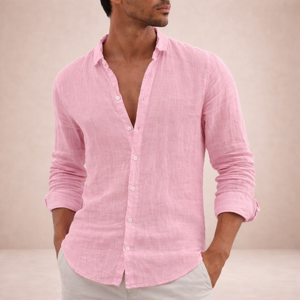 Pink linen shirt on a model with hands in the pockets of light trousers, sleeves rolled and top buttons undone. 4