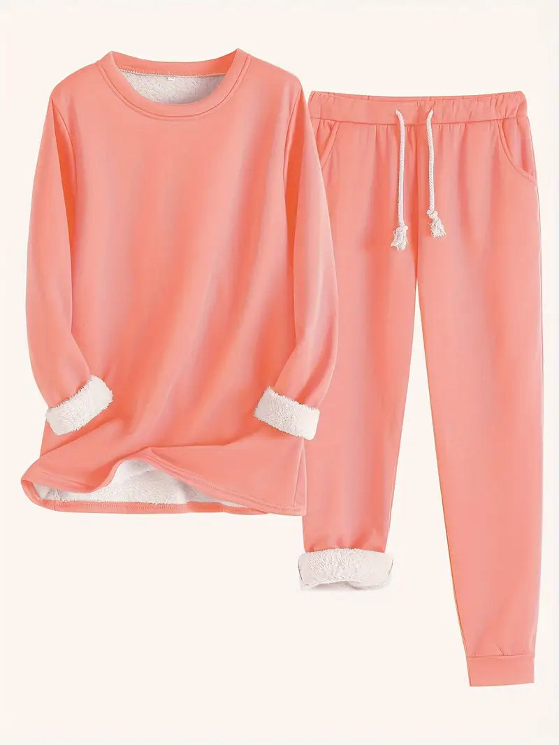 Flat lay of the set in coral orange, with white fleece lining visible at cuffs and hem 8