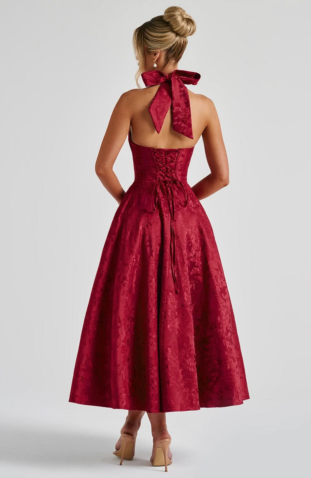 Back view of the red halter dress, showing the large neck bow, open back and lace-up corset ties. 11