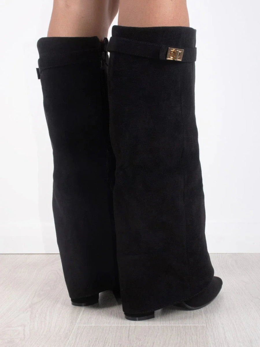 Back view of black suede-look knee boots on a model, showing the side zip and gold turn-lock strap. 4