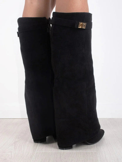 Back view of black suede-look knee boots on a model, showing the side zip and gold turn-lock strap. 4