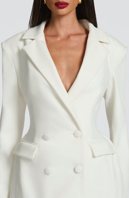 Close-up of the ivory blazer dress bodice, showing the notched lapels, flap pockets and fabric-covered buttons. 15