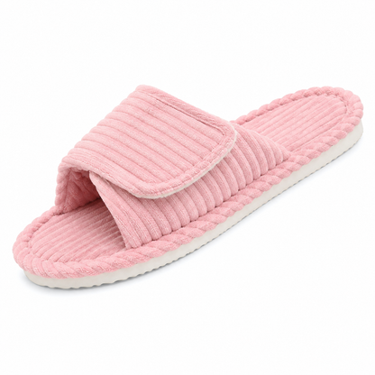 Single pink ribbed open-toe slide slipper with an adjustable strap and a white sole, shown at an angle on white. 10