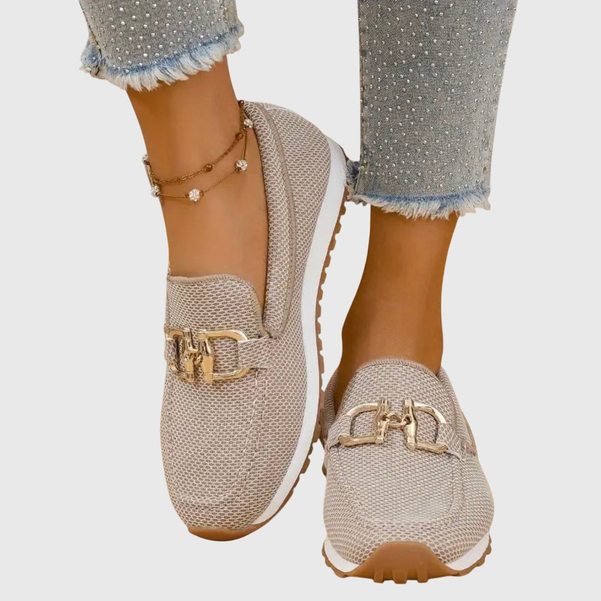 Beige mesh loafers with gold buckle worn by a model, crossed feet, front view 2