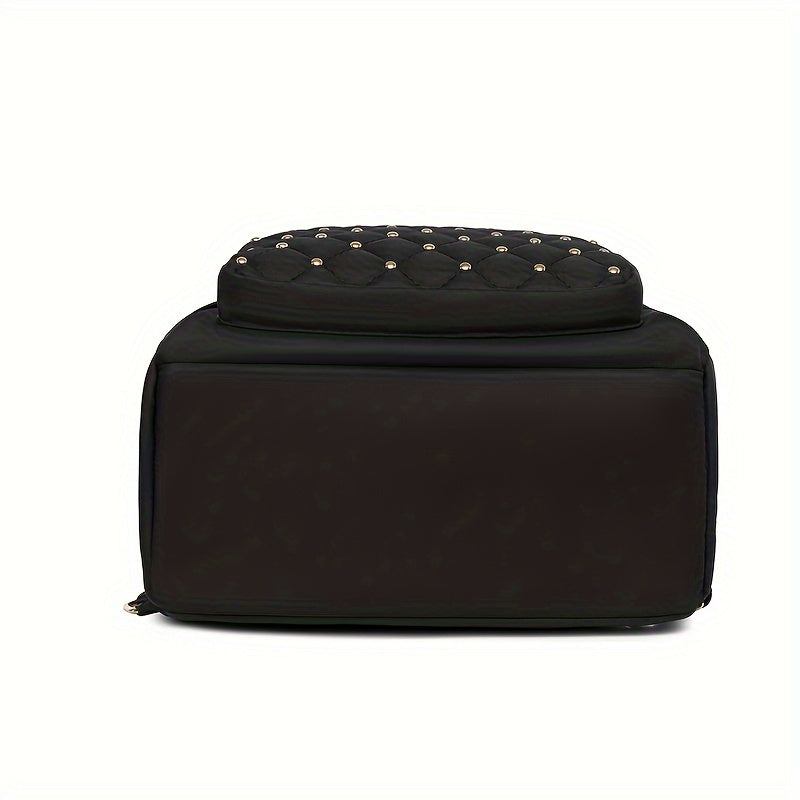 Underside of the black backpack, showing the flat base and the bottom of the quilted studded front pocket 8