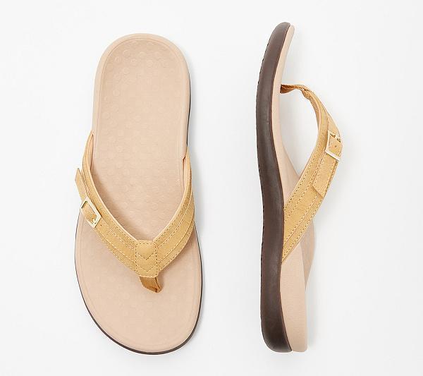 Flat lay of a mustard-yellow thong sandal from above and the side, beige footbed 8