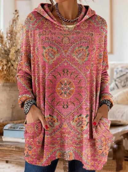Pink version with an orange and green medallion print on the ribbed knit, shown on a model with hands in the pockets. 6