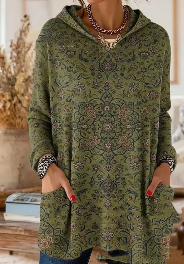 Olive green version covered in a fine floral medallion print in navy and dusty pink, worn loose with hands in the pockets. 7