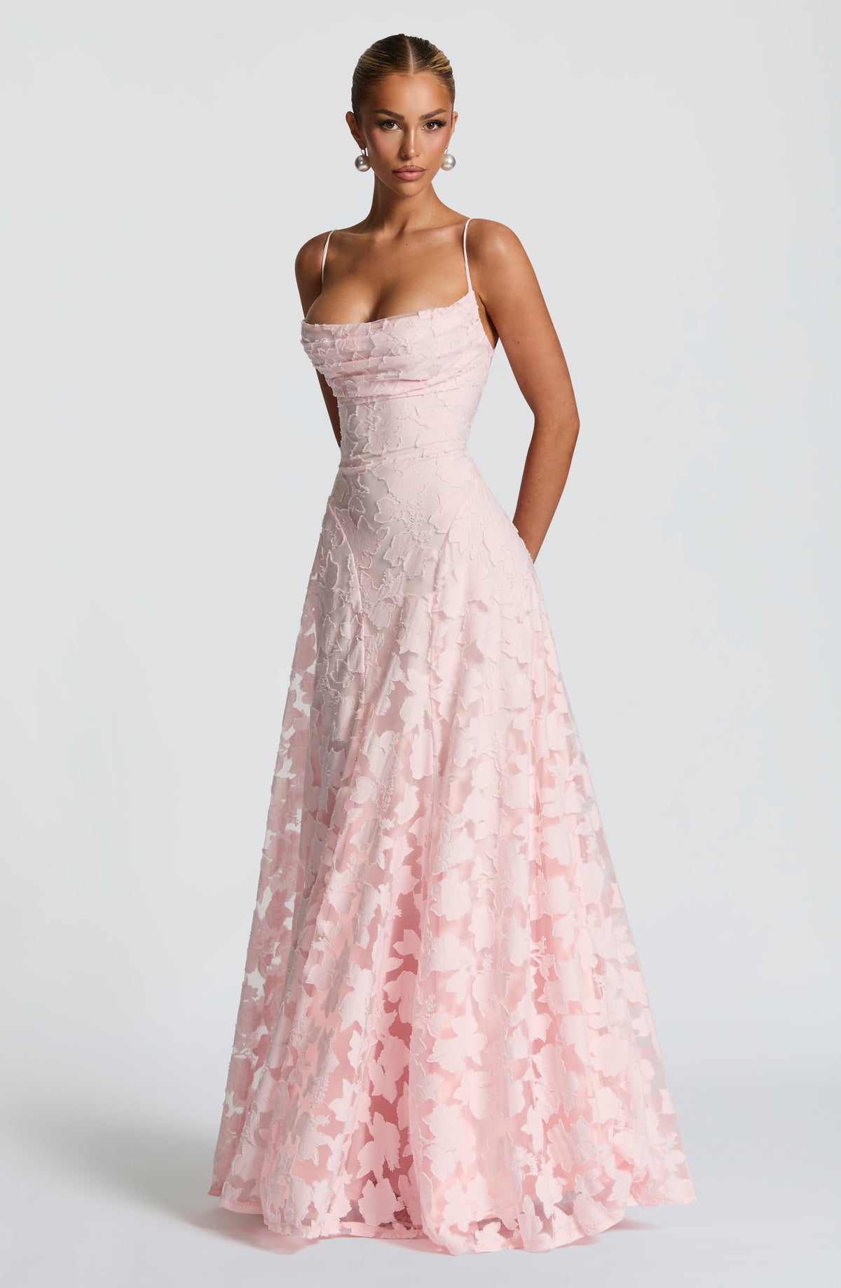 Three-quarter front view of the pale pink floral maxi dress with a full A-line skirt and ruched cowl bodice. 3