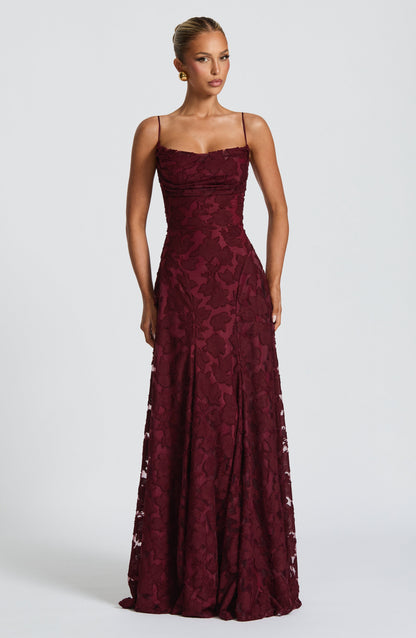Front view of the burgundy floral jacquard maxi dress with a ruched bodice, fitted waist and long skirt. 18