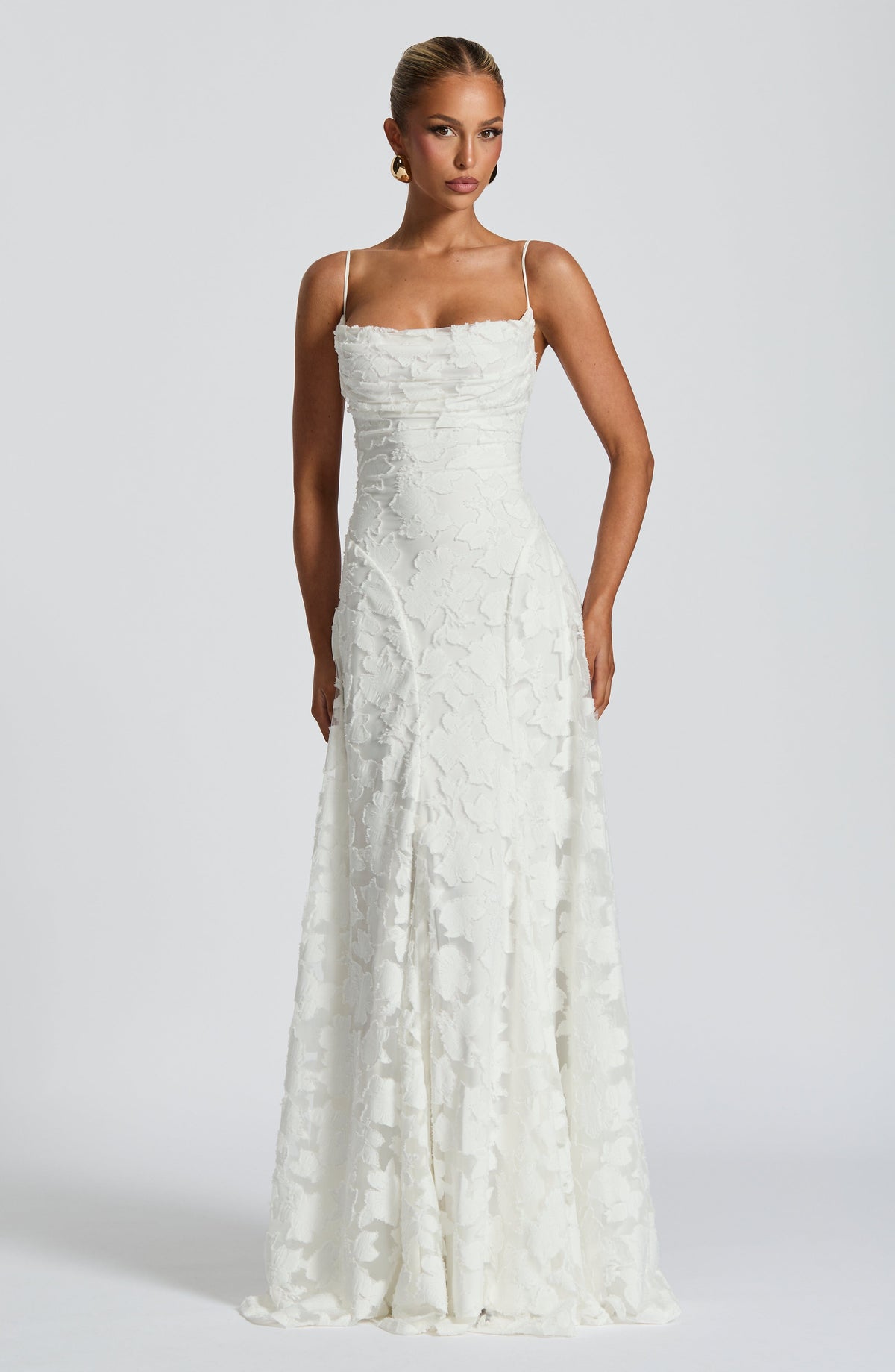 Front view of the white floral jacquard maxi dress with a cowl neckline, thin straps and a fitted waist. 8