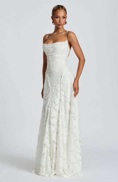 Side-angled view of the white floral maxi dress, showing the fitted bodice and long skirt falling to the floor. 9