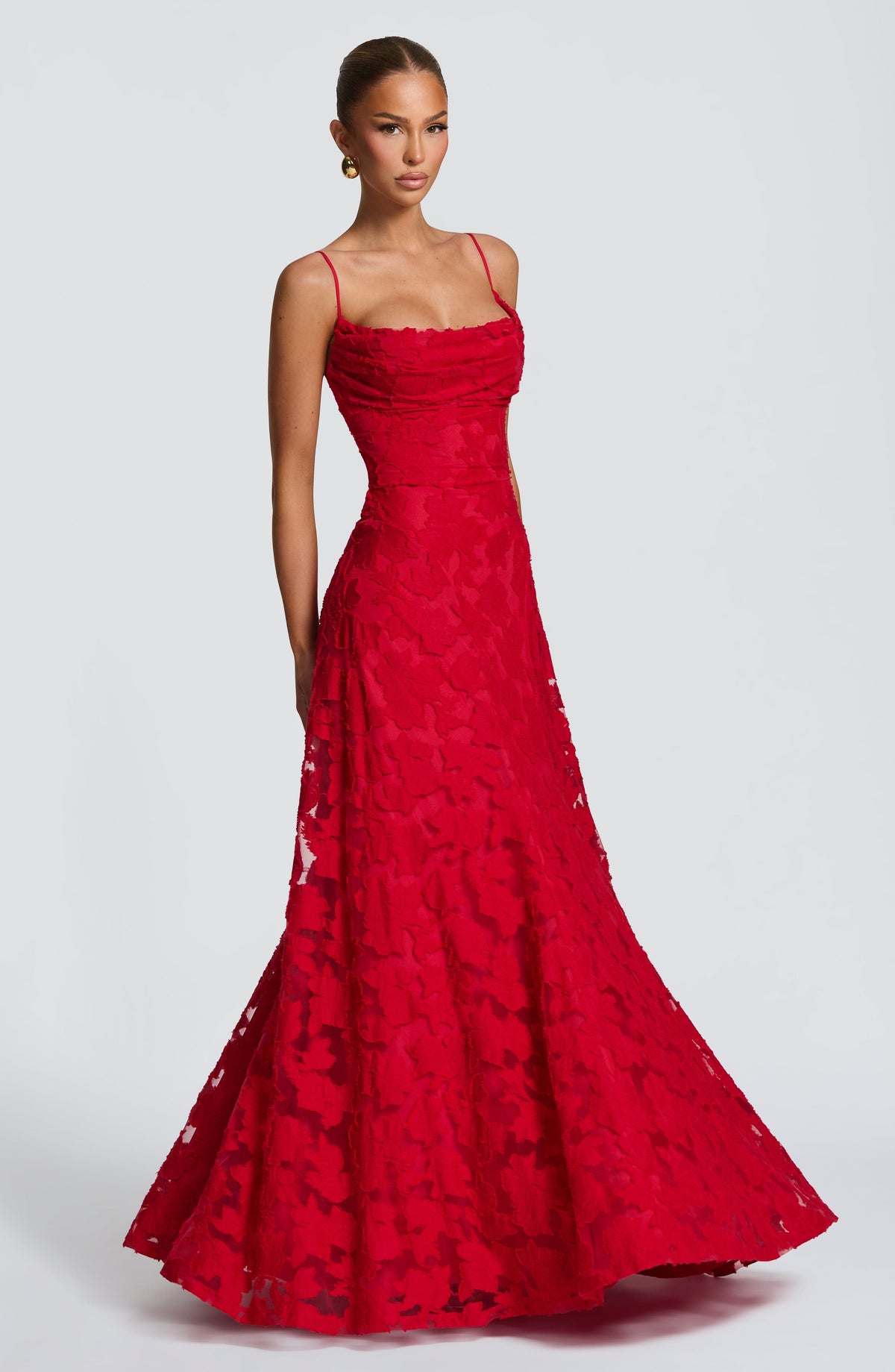 Red maxi dress worn by a model, shown from the side with the skirt flaring out towards the hem. 26