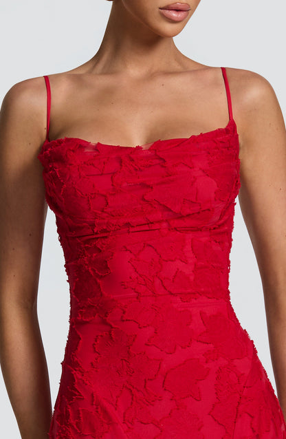 Close-up of the red dress bodice, showing the ruched cowl neckline, thin straps and raised floral texture. 28