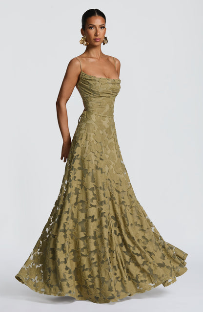 Model in the olive green dress twirling slightly, with the full floral textured skirt fanning out. 33