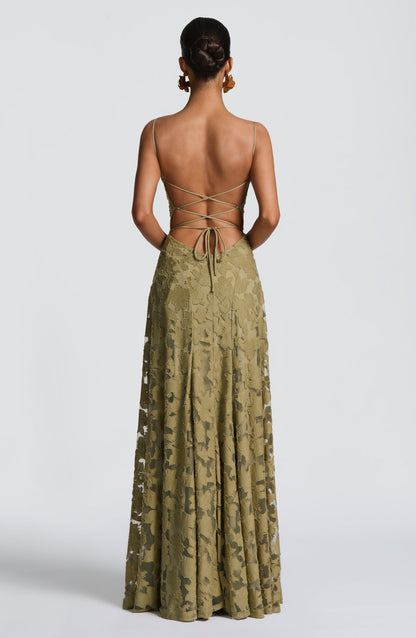 Back view of the olive green dress, showing the open back with criss-cross lacing and a bow tie at the waist. 34