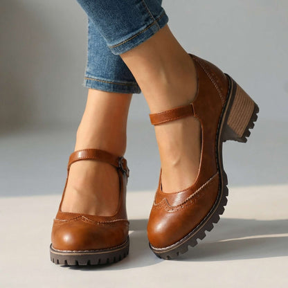 Tan-brown version worn indoors with cropped jeans, showing perforated toe cap, buckled ankle strap and chunky treaded sole 2