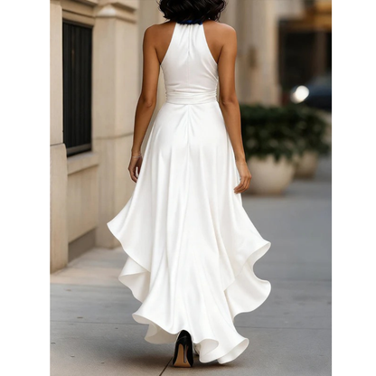 Back view of the white satin halter dress on a model, showing the closed halter back and cascading ruffles at the hem. 10