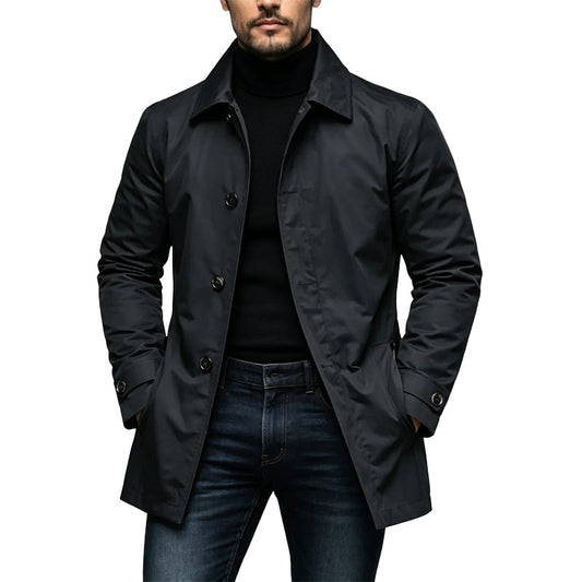 Man wearing the coat in black, buttoned over a black polo neck and dark jeans 1