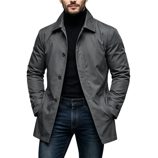 Man wearing the coat in charcoal grey with a black polo neck and jeans 2