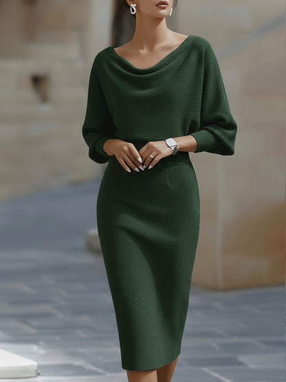 Model wearing the dark green version of the dress, front view showing the draped neckline 4