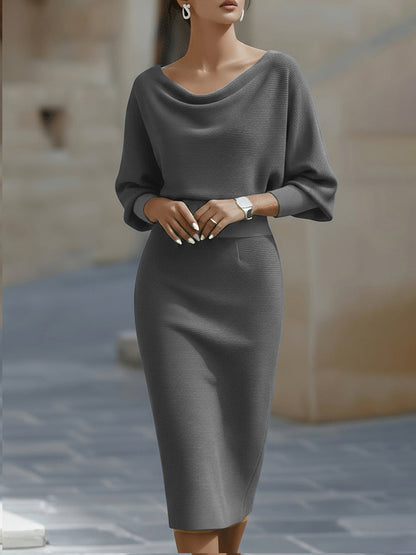 Model wearing the grey version of the dress, front view with fitted waistband and pencil skirt 5