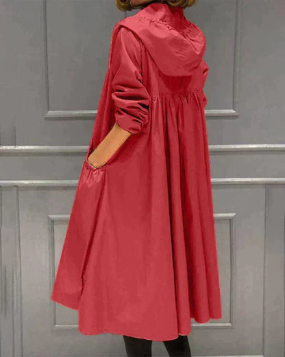 Back view of the red hooded raincoat, showing the gathered pleats below the yoke and hood 5