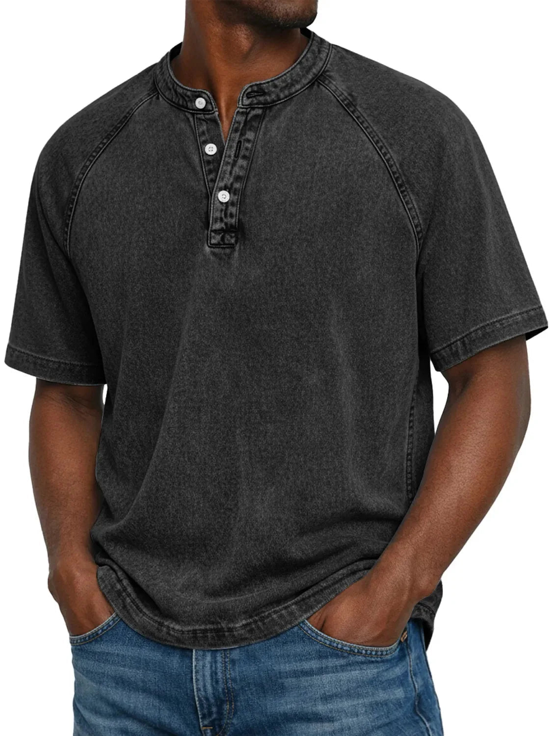 Man wearing the short-sleeved raglan Henley in washed charcoal black, front view showing the round neckline and three buttons. 5
