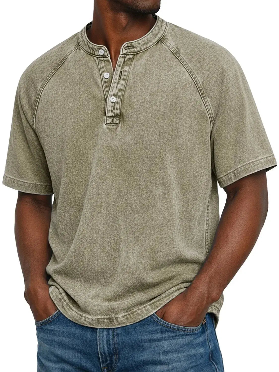 Man wearing the short-sleeved raglan Henley in washed khaki sage tone, front view with buttoned placket, paired with blue jeans. 9