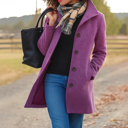 Purple version of the coat showing a matching lining, worn over a black top and jeans with a checked scarf. 5