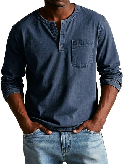 Front view of the henley in a faded navy blue, worn by a model with hands in light blue jeans. 3