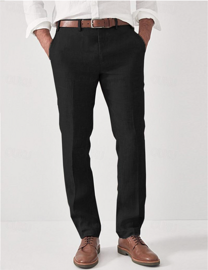Same linen trousers in black on a model, styled with a brown leather belt, white shirt and brown lace-up shoes. 3