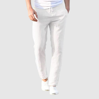 Front view of the trousers in white, worn by a model with a white T-shirt and white plimsolls. 6