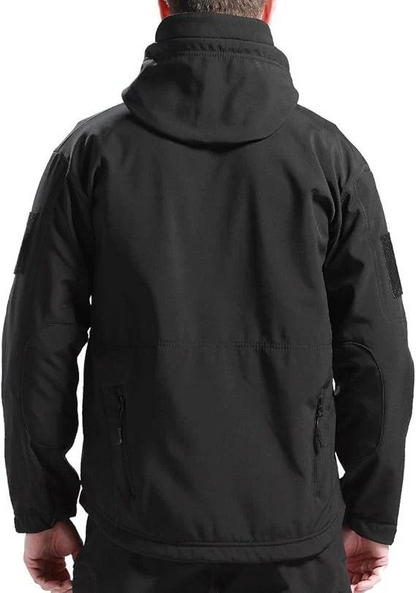 Back view of a man wearing the black hooded jacket, showing the seam across the lower back and zipped hand pockets. 7