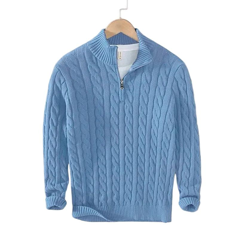 Light blue cable knit jumper hanging on a wooden hanger, with the short zip and ribbed collar 3