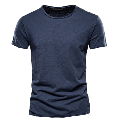Front view of the short-sleeved crew neck t-shirt in dark navy, with visible slub yarn texture and raw-edged neckline. 2