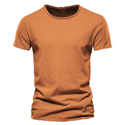 Front view of the short-sleeved crew neck t-shirt in burnt orange, showing the streaky slub texture and raw-edged hems. 8