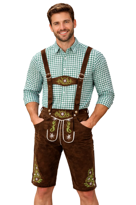 Smiling man on a plain white background wearing dark brown embroidered lederhosen with braces over a green and white checked shirt, hands in pockets. 1