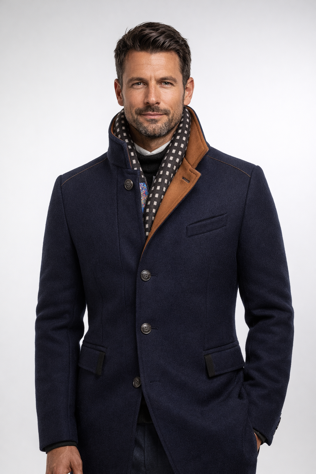 Model wearing the navy coat buttoned with the stand collar up, showing the tan facing and scarf 13