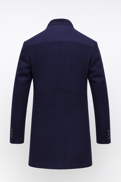 Back of the navy coat, showing panelled seams, a knitted collar edge and three buttons on each cuff 5