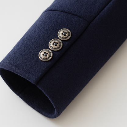Close-up of a navy sleeve cuff with three antique-finish buttons in a row 7