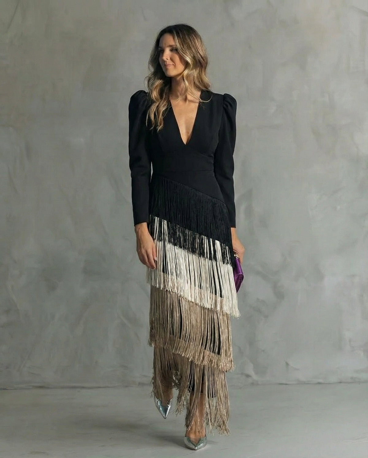 Black bodice dress with tiered fringe shading from black to white and beige, worn by a model 5