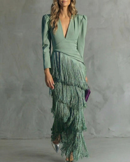 Close front view of a sage green tiered fringe dress with a deep V-neck and puff shoulders 1