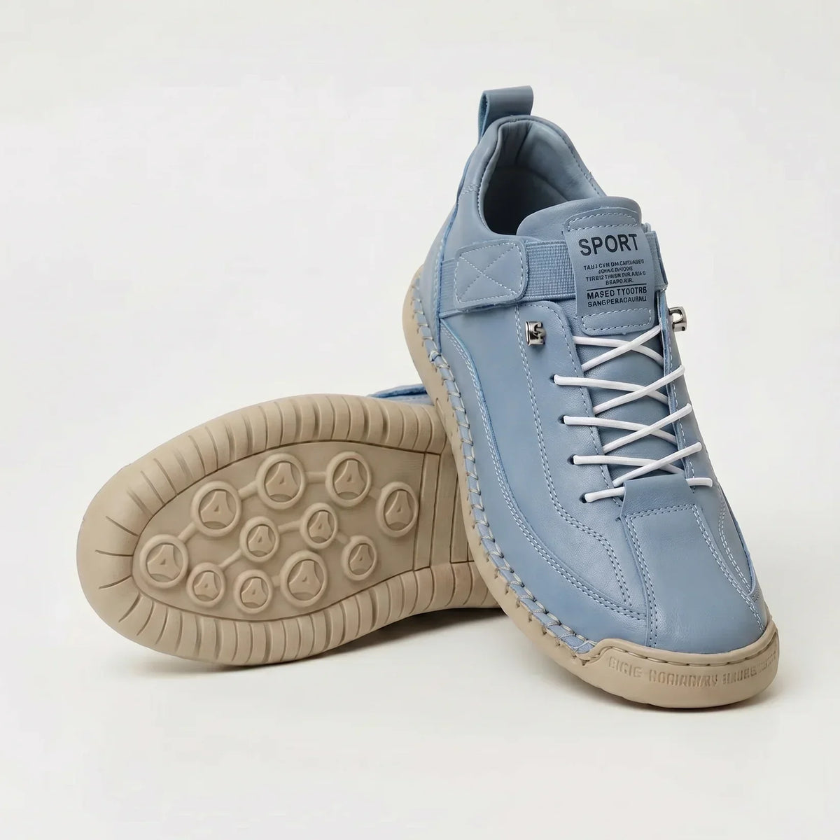 Pale blue trainers with white laces and tan sole, one upright with the other showing its tread 11