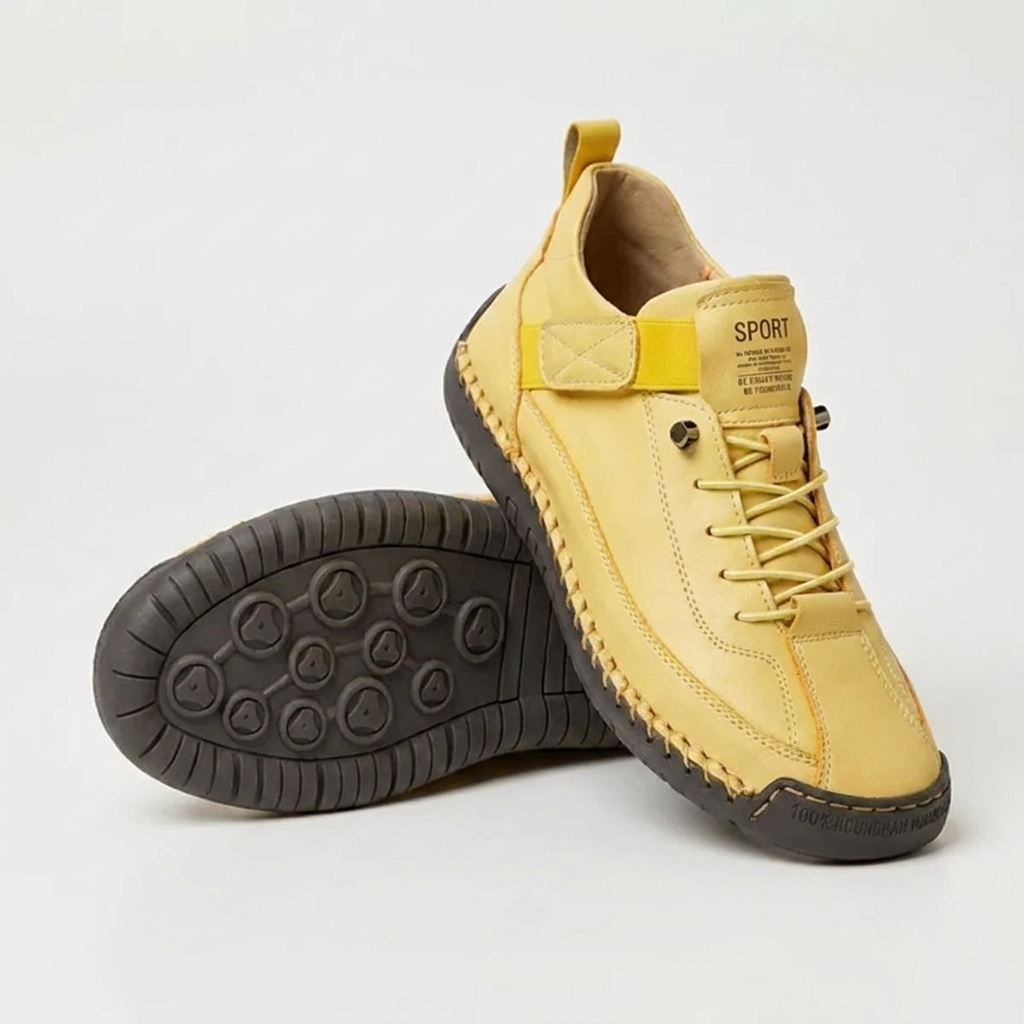 Yellow trainers with elastic strap and dark brown sole, one upright and one sole-up showing circular tread 13