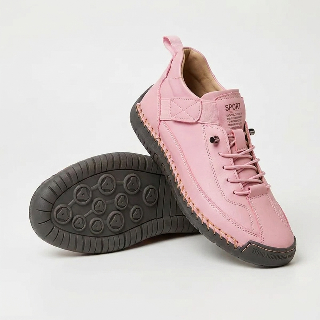 Pink trainers with dark grey sole and orange stitching, one upright, one turned to show the grip pattern 14