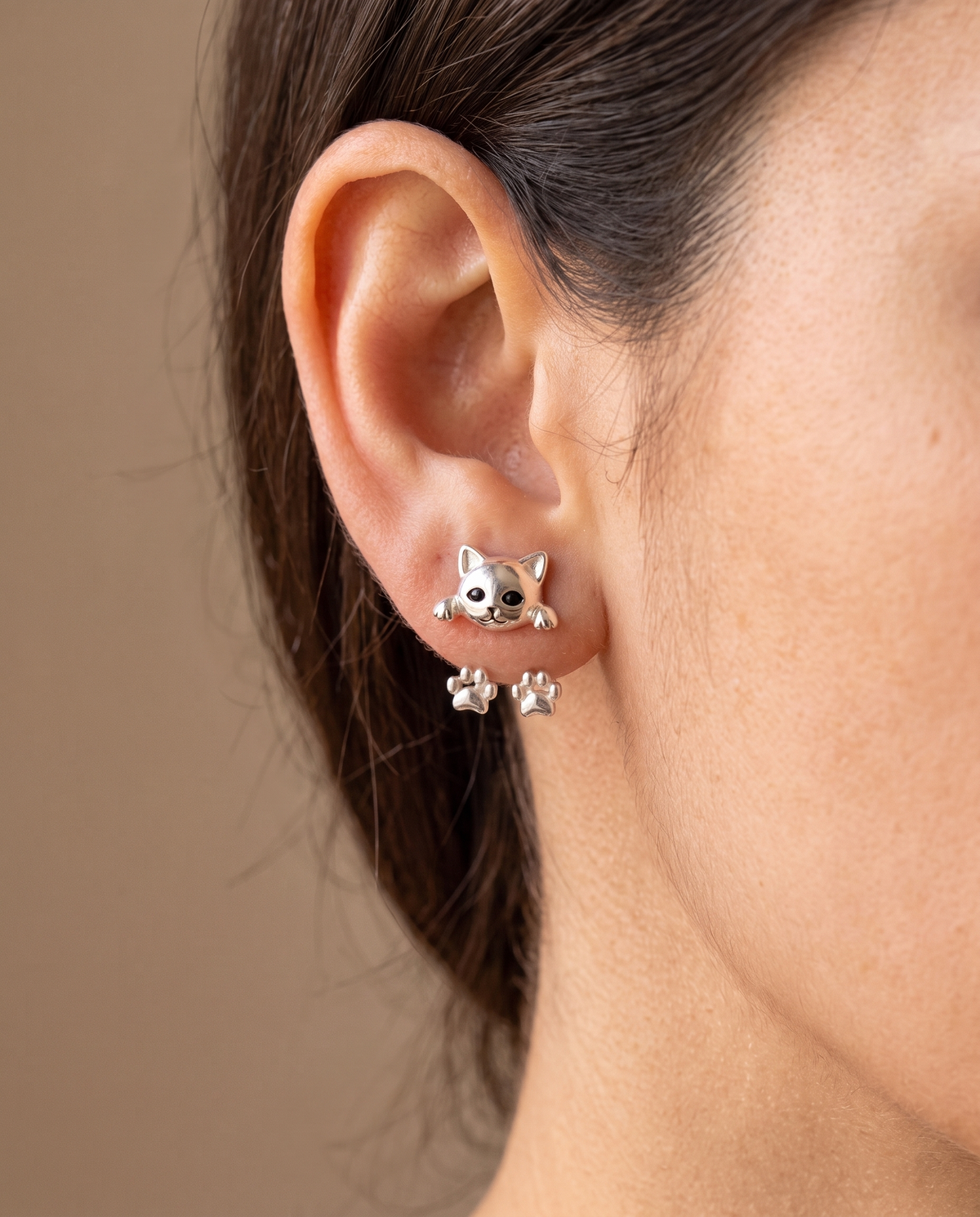 Model's ear wearing one cat earring, with the paw jacket hanging softly behind the lobe 2