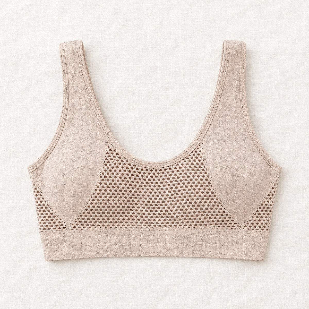 Back of the beige bra laid flat, showing wide straps, a scooped neckline and large honeycomb mesh panel 8